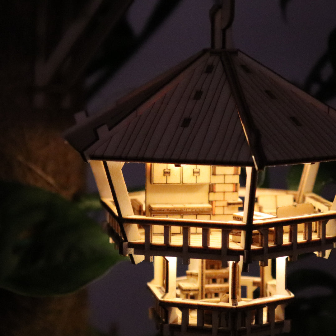 Tiny Treehouses 3D Puzzle Lighted model of a pagoda with intricate details against a dark background