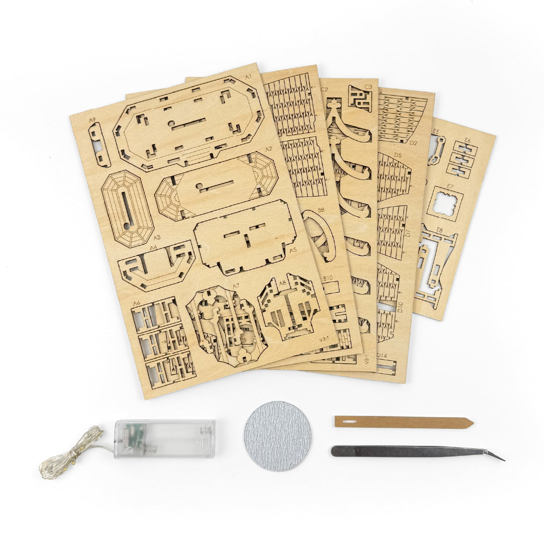Tiny Treehouses 3D Puzzle Set of laser-cut wooden Tiny Treehouse 3D Puzzle models with tools on a white background