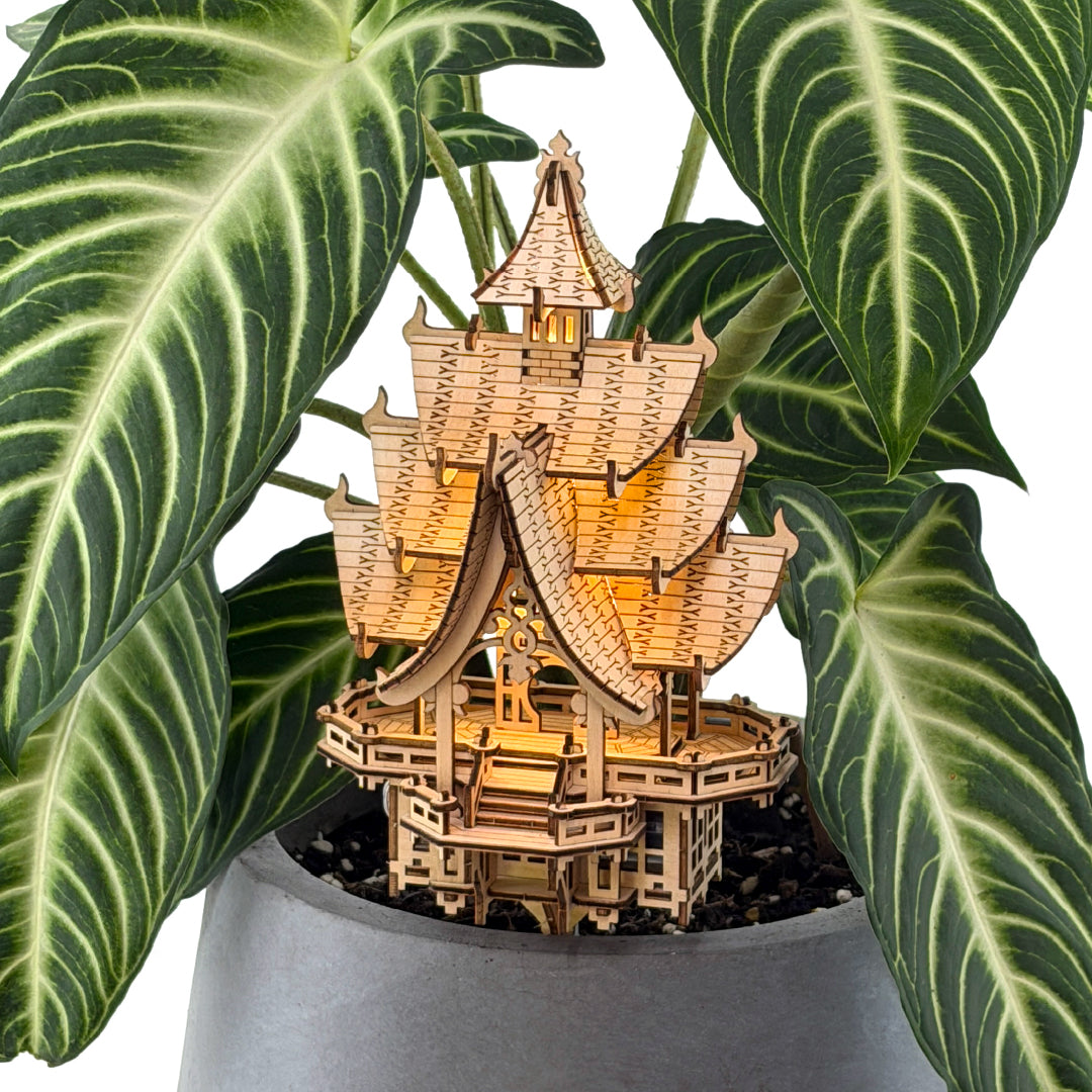 Tiny Treehouses 3D Puzzle Wooden temple Tiny Treehouse 3D Puzzle model in a pot with green leaves